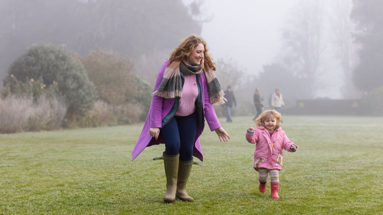 A family exploring the gardens in winter at Hinton Ampner, Hampshire